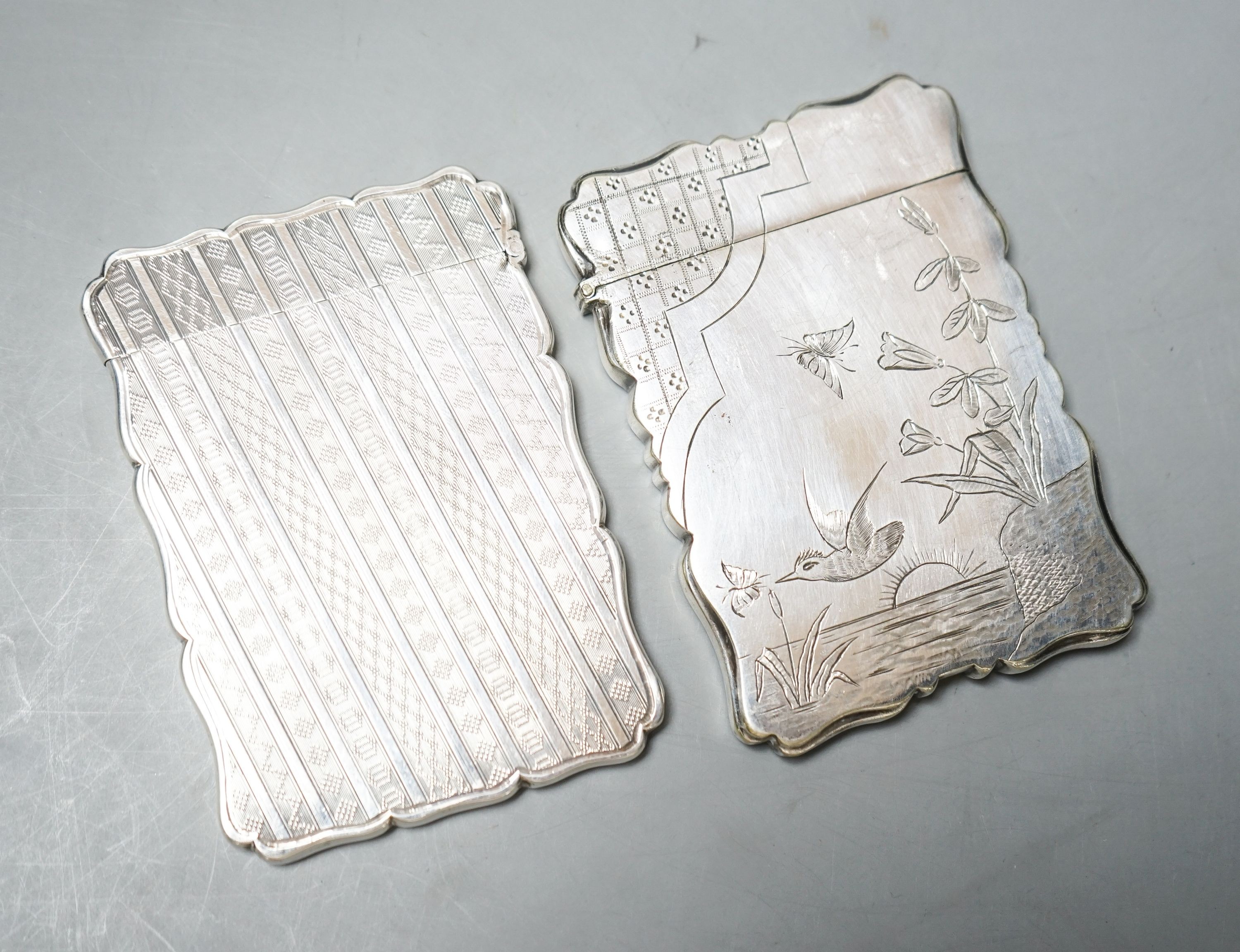 A Victorian engraved silver card case, Edward Smith, Birmingham, 1865, 9.8cm and a silver plated card case with engraved aesthetic decoration.